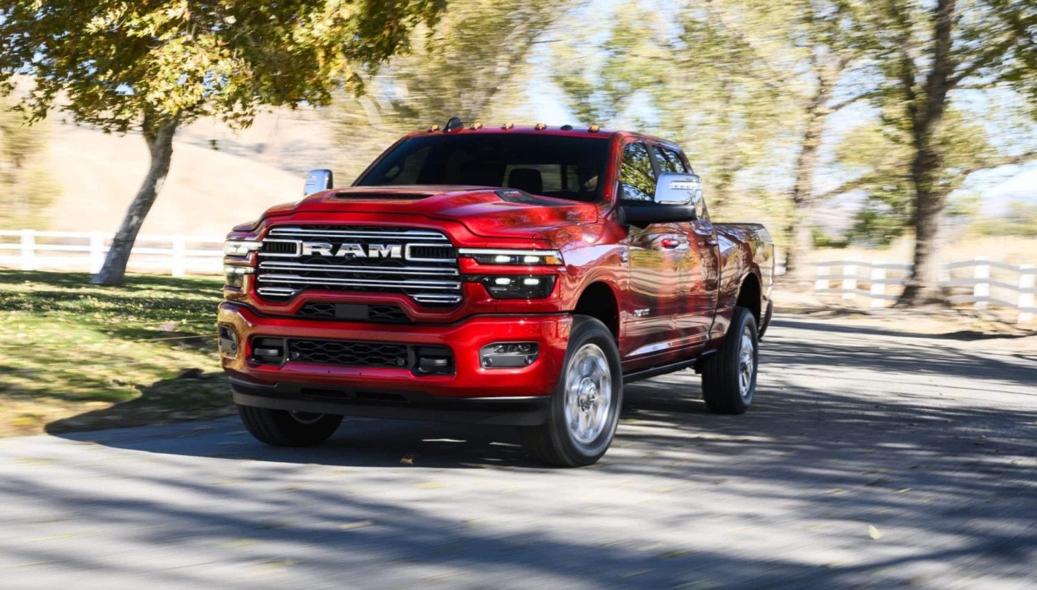Red 2026 Ram 2500 Laramie heavy duty truck on a paved country road