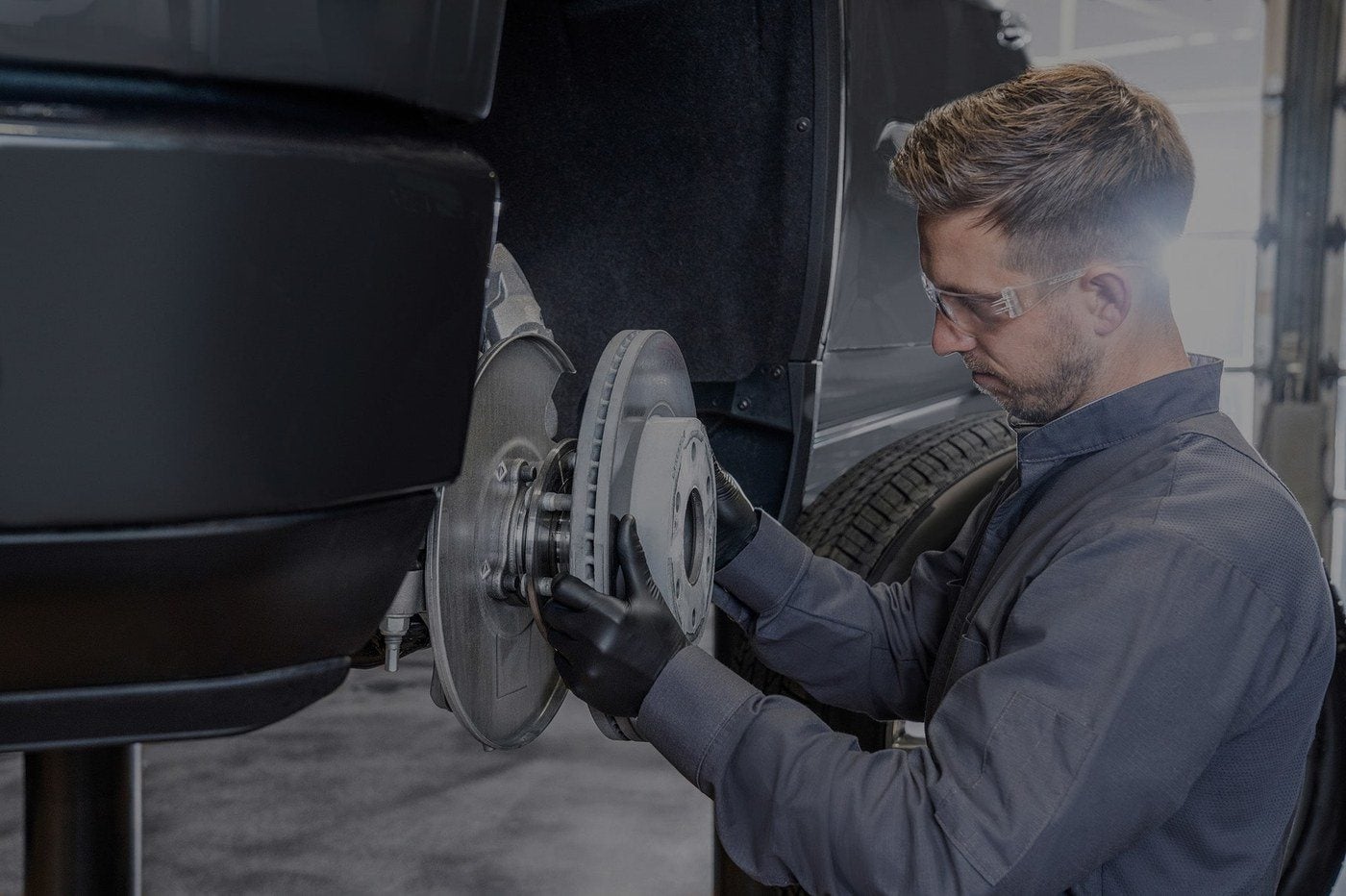 Technician replacing a brake rotor during brake service in Graham, Texas