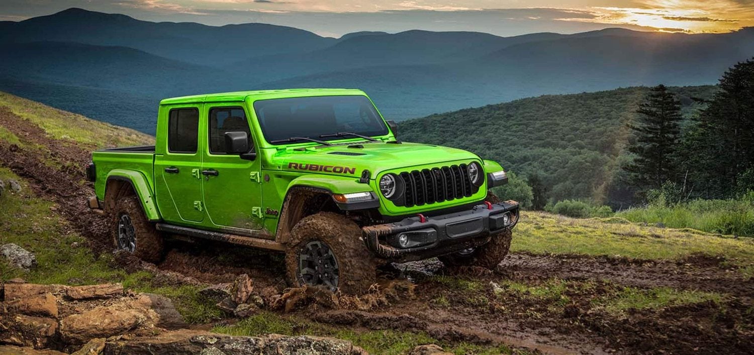 Lime green 2026 Jeep Gladiator Rubicon X slogging through mud